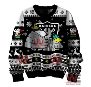 Alt text: Close-up of a black sweater with Peanuts characters Snoopy, Woodstock, and Charlie Brown, along with the Raiders logo and winter-themed designs.