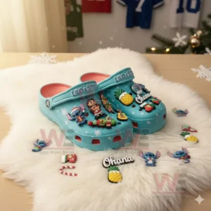 Blue clogs covered with assorted character and holiday themed charms displayed on a white furry mat!