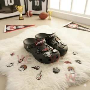 Black Linkin Park-themed Crocs with guitars, band logos, and other charms displayed on a fluffy rug with sports memorabilia.