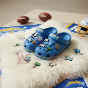 Los Angeles Chargers Crocs inside a box with football-themed charms, including helmets and lightning bolts.
