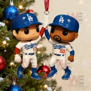 A Christmas ornament of two Los Angeles Dodgers baseball players giving a high five hanging on a decorated tree with colorful ornaments and lights!
