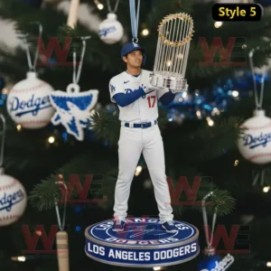 A World Series championship themed ornament with the Dodgers logo baseballs and blue ribbon hanging on a Christmas tree.