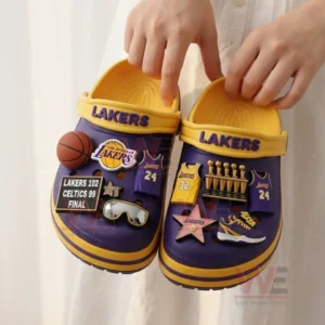 Person holding Los Angeles Lakers-themed Crocs with charms.