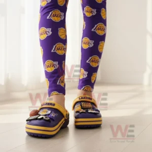 Person wearing Los Angeles Lakers-themed Crocs with matching leggings.