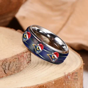 A shiny blue ring with rams symbols arranged evenly on a textured wood background!