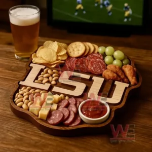 A wooden platter with an LSU design surrounded by assorted snacks sits near a glass of beer with a sports game on a television!