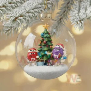 M&M'S Christmas Ornament 2025 10 A clear glass ornament containing two M and M characters decorating a Christmas tree in a snowy miniature holiday scene!