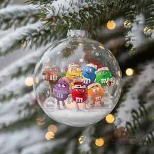 M&M'S Christmas Ornament 2025 11 A clear ornament filled with several M and M characters wearing holiday themed outfits standing on a snowy base!