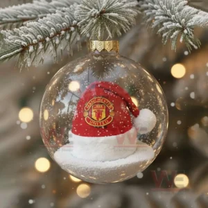 Manchester United Christmas Ornament 2025 11 A transparent ornament showing a red Santa hat resting on snow inside a glass globe!