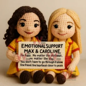 Max and Caroline Emotional Support Doll 5 Two crochet dolls in matching yellow outfits sitting together holding a shared supportive message sign!