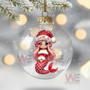 A clear ornament showing a small mermaid in a red holiday hat in a snowy scene!