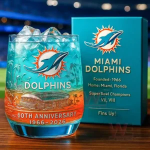 A close up view of a Miami Dolphins anniversary glass with ice placed in front of a matching box with a stadium backdrop!