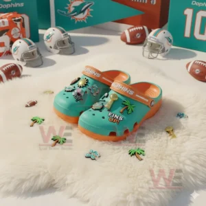 Miami Dolphins Crocs Crocband Clogs With Charms 7 Alt text: Miami Dolphins-themed Crocs with NFL-themed charms on a fluffy white rug with football items.