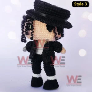Michael Jackson Emotional Support Doll 6 A crochet doll in a black outfit with a black hat and silver glove standing in a dance pose!