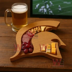 A warrior shaped wooden platter filled with assorted snacks sits near a glass of beer with a sports game on a television!