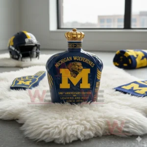 Michigan Wolverines bottle with gold crown on white rug with helmet and foam finger!
