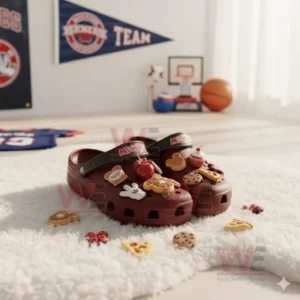 Red clogs covered with assorted character inspired charms displayed on a white furry surface in a sunlit room!