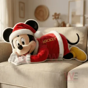 A holiday themed character pillow lying on a beige sofa in a softly lit room!