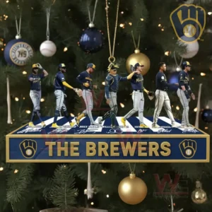 A row of baseball player figures stands on a team themed ornament hanging from a Christmas tree with gold and blue decorations behind them!