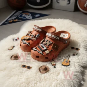 Brown Morgan Wallen Crocs decorated with music and country themed charms on a soft white rug!