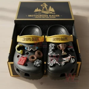 Black motocross themed clogs placed inside an open box with multiple racing charms attached to the shoes.