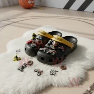 MotoCross Racer Crocs Crocband Clogs 5 Black clogs with motocross racing charms placed on a white fluffy rug surrounded by additional charms.
