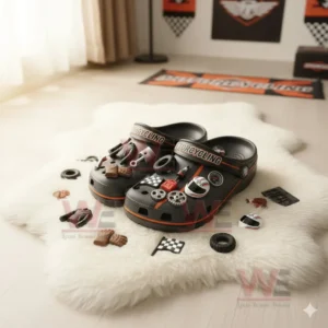 Motorcycle themed clogs with various racing and mechanical charms displayed on a fluffy white mat.!