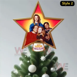 A golden star tree topper showing the family from the Christmas Vacation movie with a glowing red and gold background.
