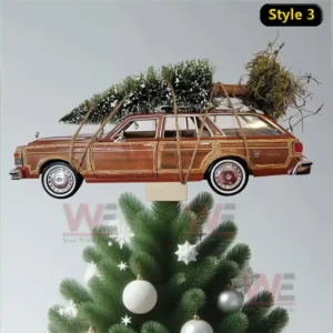 A vintage car Christmas tree topper carrying a snow covered tree tied to its roof with ropes.
