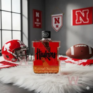 Nebraska Huskers bottle on white rug with football helmets and team flags!
