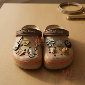 Neil Young Crocs shown with musical and nature inspired decorations on a wooden surface!
