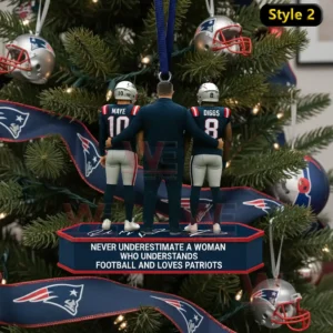 A Christmas ornament displaying two New England Patriots players and a coach positioned on a decorated stand with holiday elements in the background!