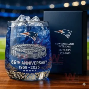 New England Patriots 66th Anniversary Whiskey Glass 3 Alt text: A close-up of a New England Patriots 66th Anniversary whiskey glass with a stadium design and a gift box, with a football stadium backdrop.
