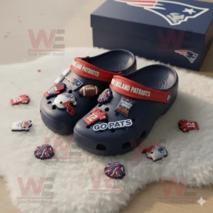 New England Patriots Crocs with scattered themed charms on a fluffy white rug!