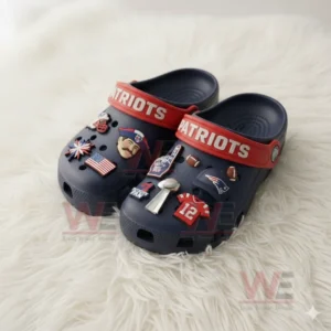 Navy clogs with Patriots charms placed on a soft white fur surface!