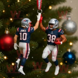 A Christmas ornament of two New England Patriots football players giving a high five hanging on a decorated tree with colorful lights and ornaments!