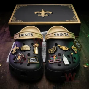 Black Saints clogs with charms displayed before a black and gold themed box!