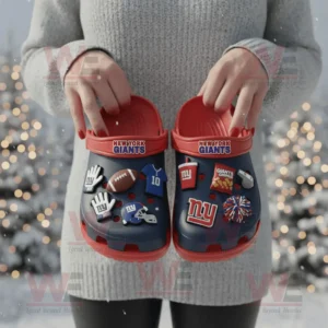 New York Giants Crocs with charms being held outdoors in a snowy festive scene!