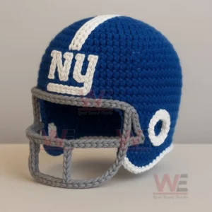 Crocheted blue football helmet with white lettering and a gray yarn face guard placed on a light surface!