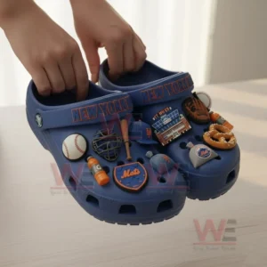 Blue New York Mets clogs with multiple themed charms held in hands.