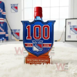 A blue one hundred year New York Rangers bottle with a red cap sits on a white rug in a hockey themed room!