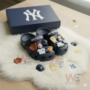 Navy Yankees clogs with baseball themed charms displayed on a white furry surface!