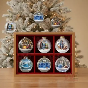 A Christmas ornament featuring a North Carolina Tar Heels football helmet surrounded by snow and festive holiday elements.