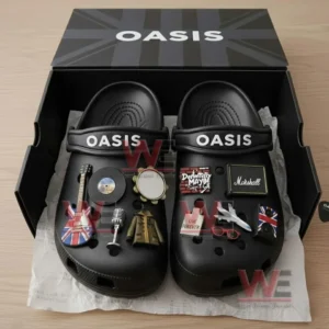 Oasis Crocs with Charms 7 A boxed pair of Oasis themed black Crocs decorated with musical charms and British rock symbols.