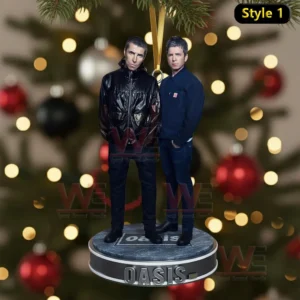 Two band members stand on a round ornament hanging on a Christmas tree with blurred red black and silver decorations behind them.