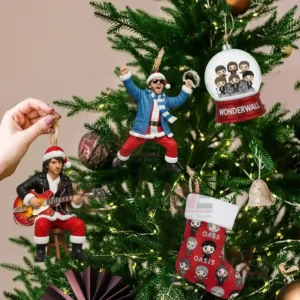 Oasis band themed ornaments including Santa figures and a Wonderwall snow globe hanging on a Christmas tree.