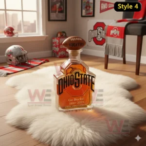 Ohio State Buckeyes Go Bucks 1890-2025 135th Anniversary Whiskey Bottle 7 An Ohio State bottle with a football topper rests on a rug in a well lit room decorated with Ohio State items.