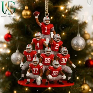 Football themed Christmas ornament showing players stacked in a pyramid formation with festive decorations in the background!