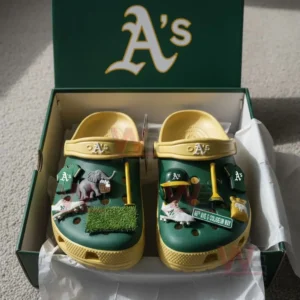 Green and yellow Oakland Athletics Crocs decorated with baseball-related charms inside a team-branded box.
