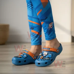 Person wearing Oklahoma City Thunder-themed Crocs with matching leggings.